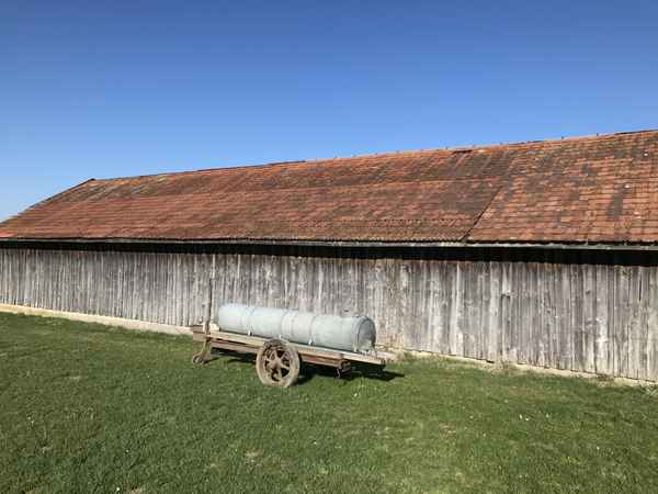 Holzscheune und Wasserfass