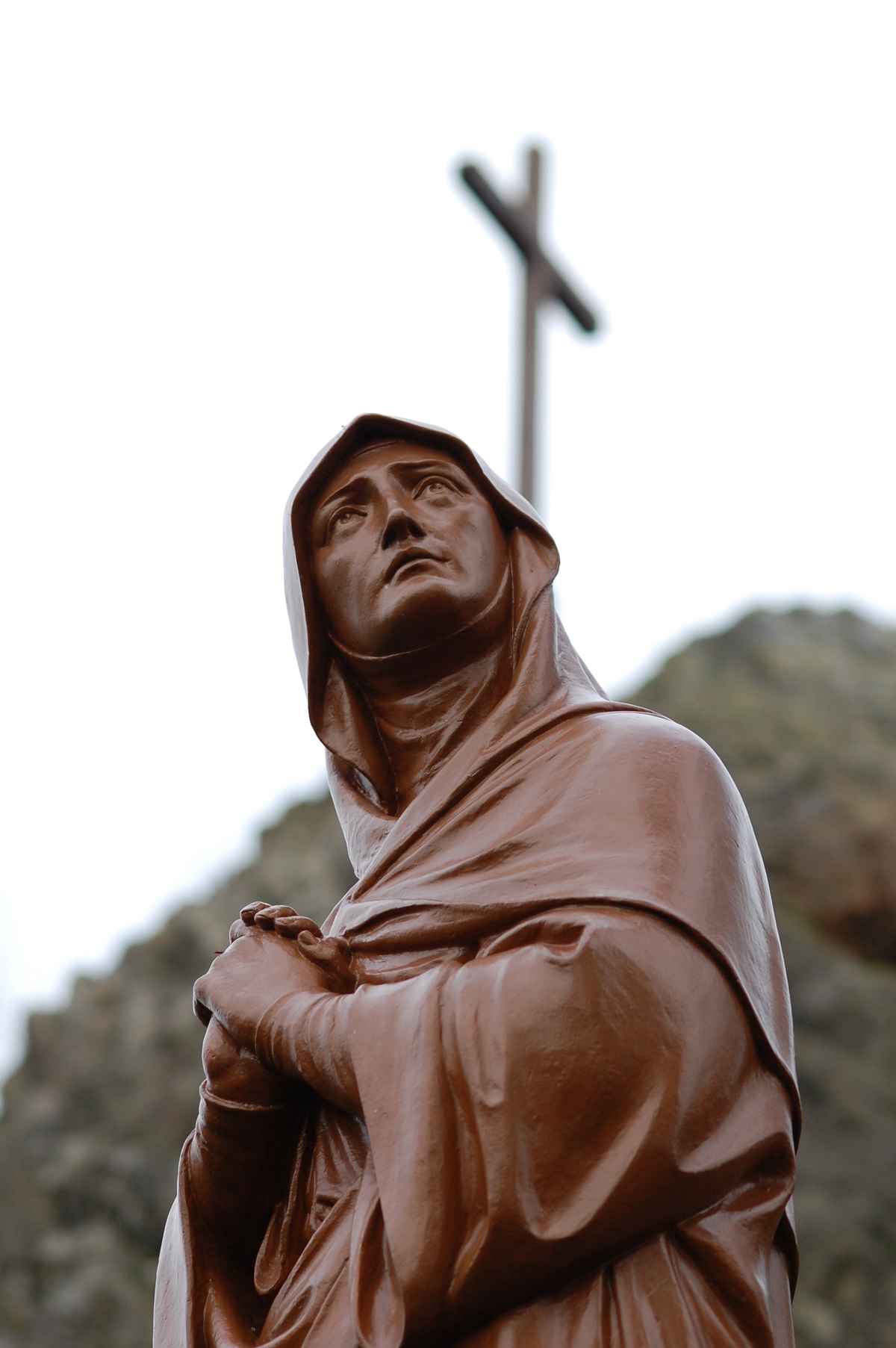 Heilige mit Kreuz im Hintergrund