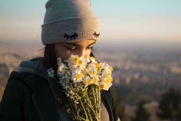 Girl smelling flower